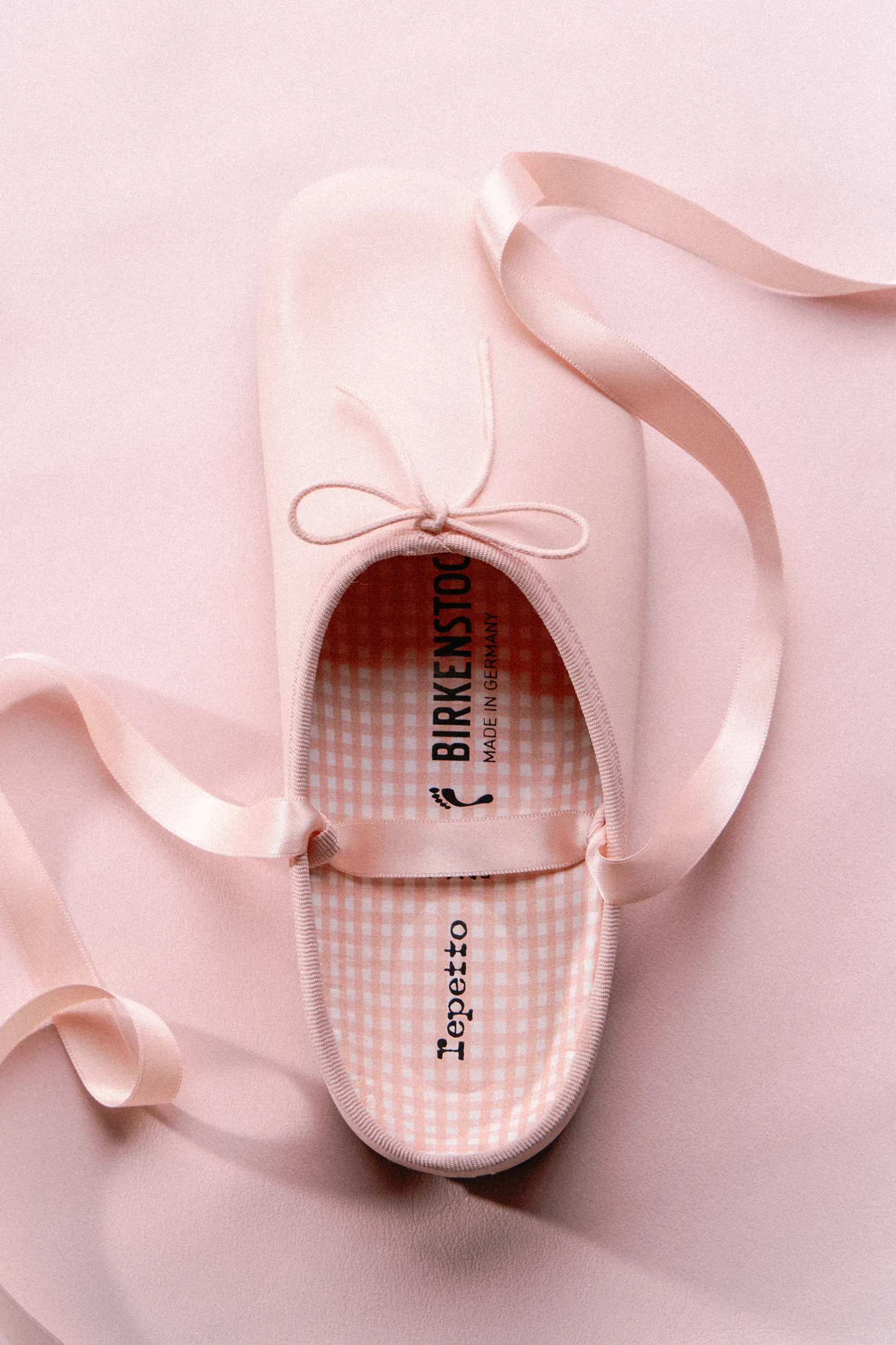 Birkenstock x Repetto ballet slipper with satin ribbon on pink background