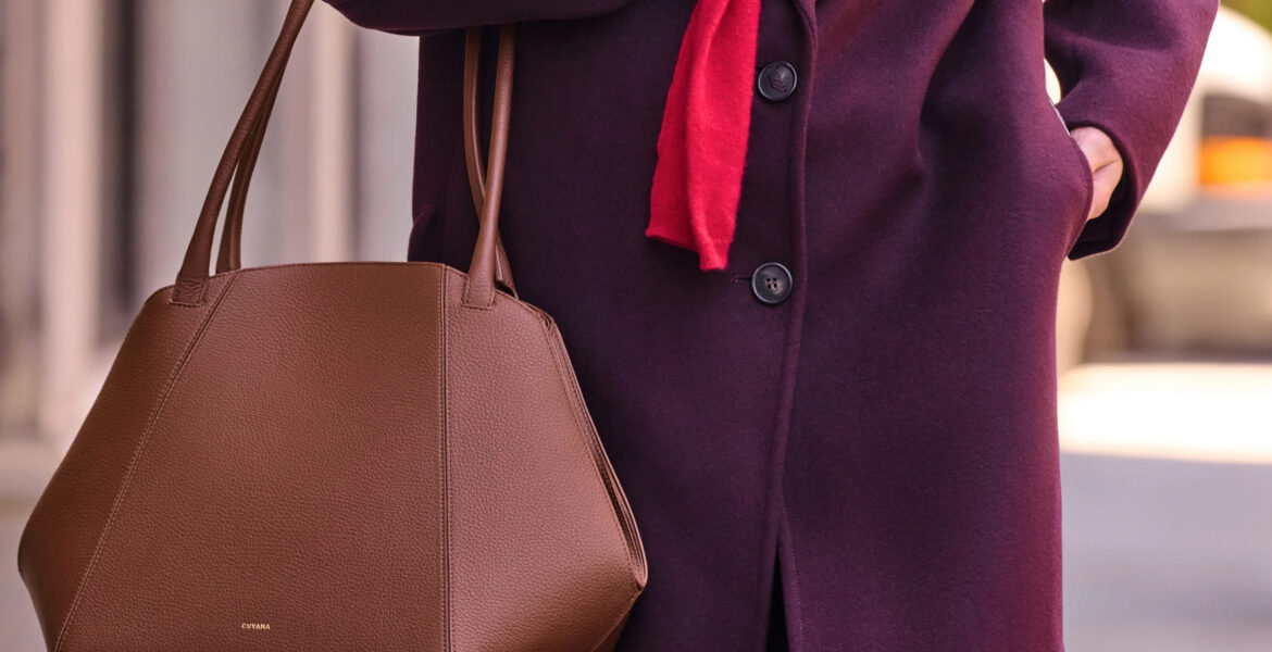 Cuyana leather handbag styled with a burgundy coat
