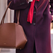 Cuyana leather handbag styled with a burgundy coat