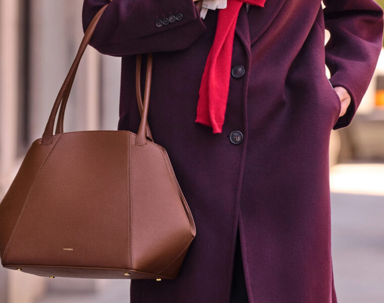 Cuyana leather handbag styled with a burgundy coat