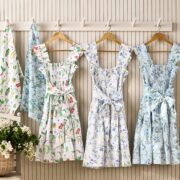 Hill House x Williams Sonoma aprons in three prints hanging on a wall