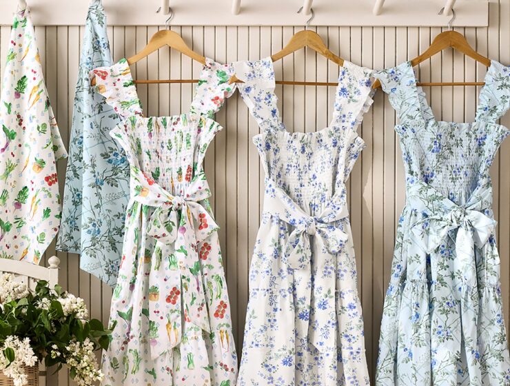 Hill House x Williams Sonoma aprons in three prints hanging on a wall