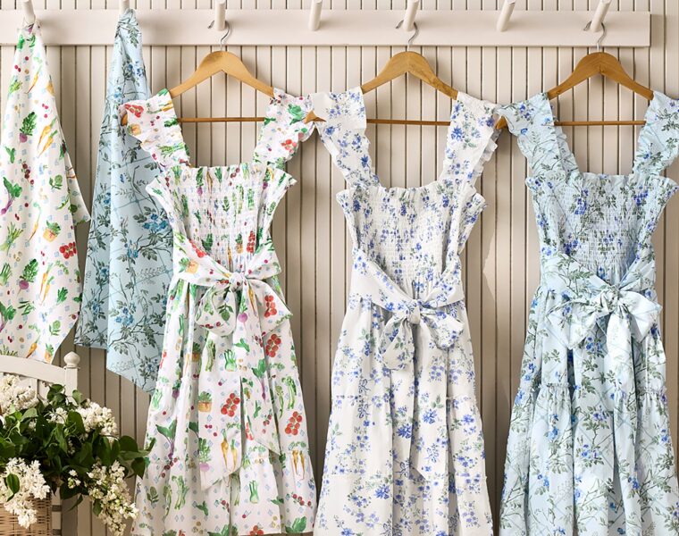 Hill House x Williams Sonoma aprons in three prints hanging on a wall
