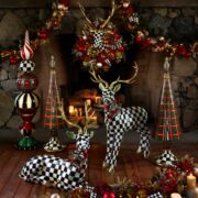 MacKenzie-Childs holiday decor with black-and-white checkered reindeer, plaid trees, bows and Christmas garland