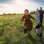 The Ingalls family running through a field in Netflix's Little House on the Prairie reboot (2026)