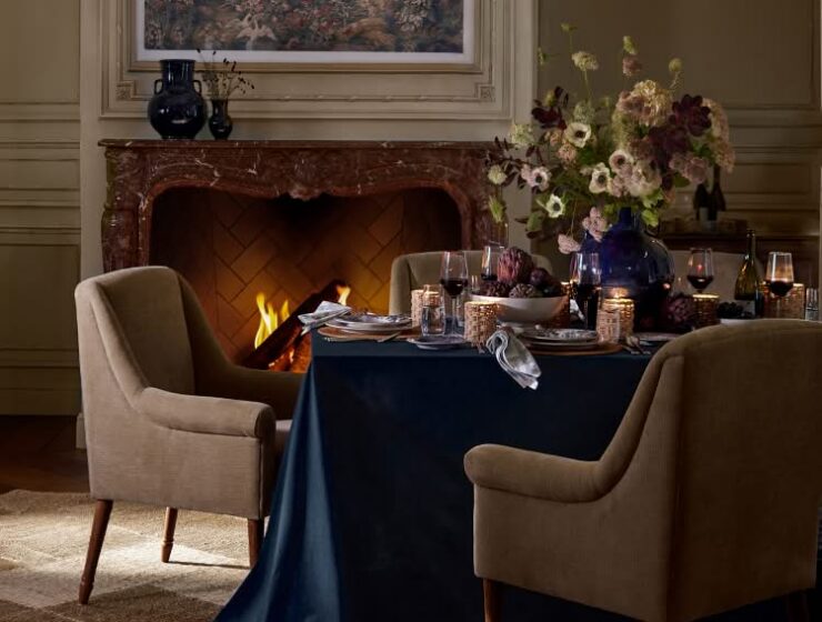 Pottery Barn x Kravet Fall collection dining room with a floral table and fireplace