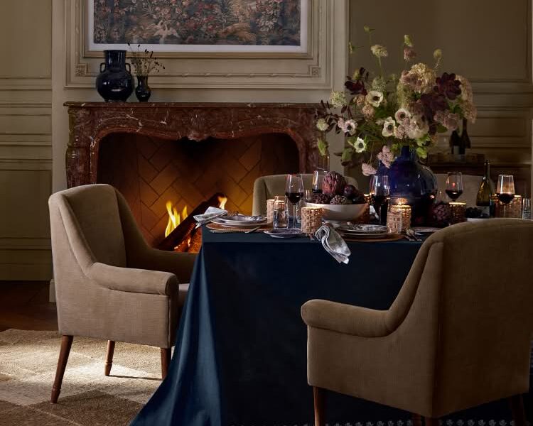 Pottery Barn x Kravet Fall collection dining room with a floral table and fireplace
