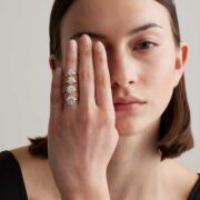 A woman displaying solitaire diamond rings