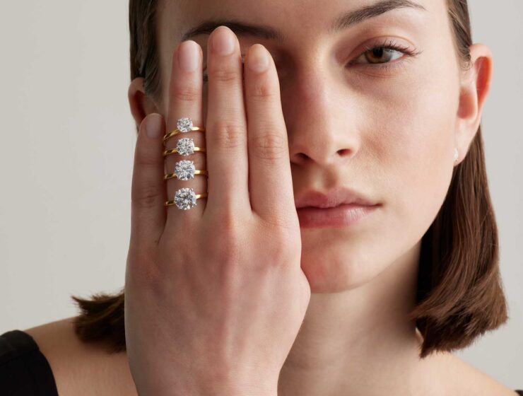 A woman displaying solitaire diamond rings