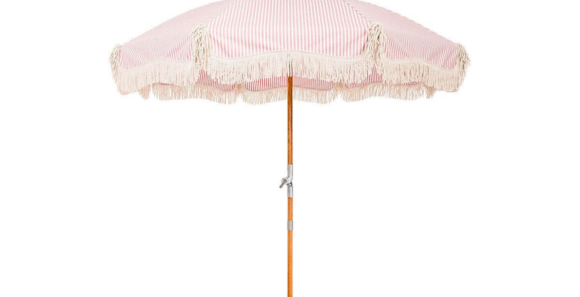 Pink striped Business & Pleasure Premium Beach Umbrella on the sand