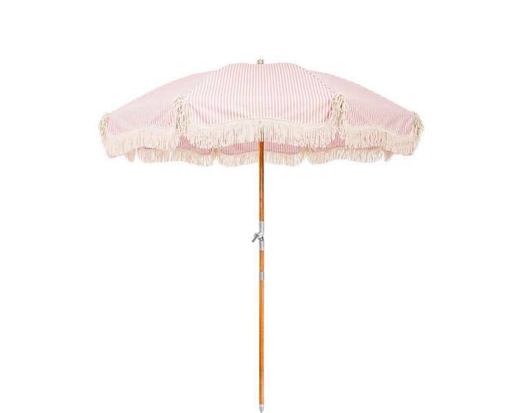 Pink striped Business & Pleasure Premium Beach Umbrella on the sand